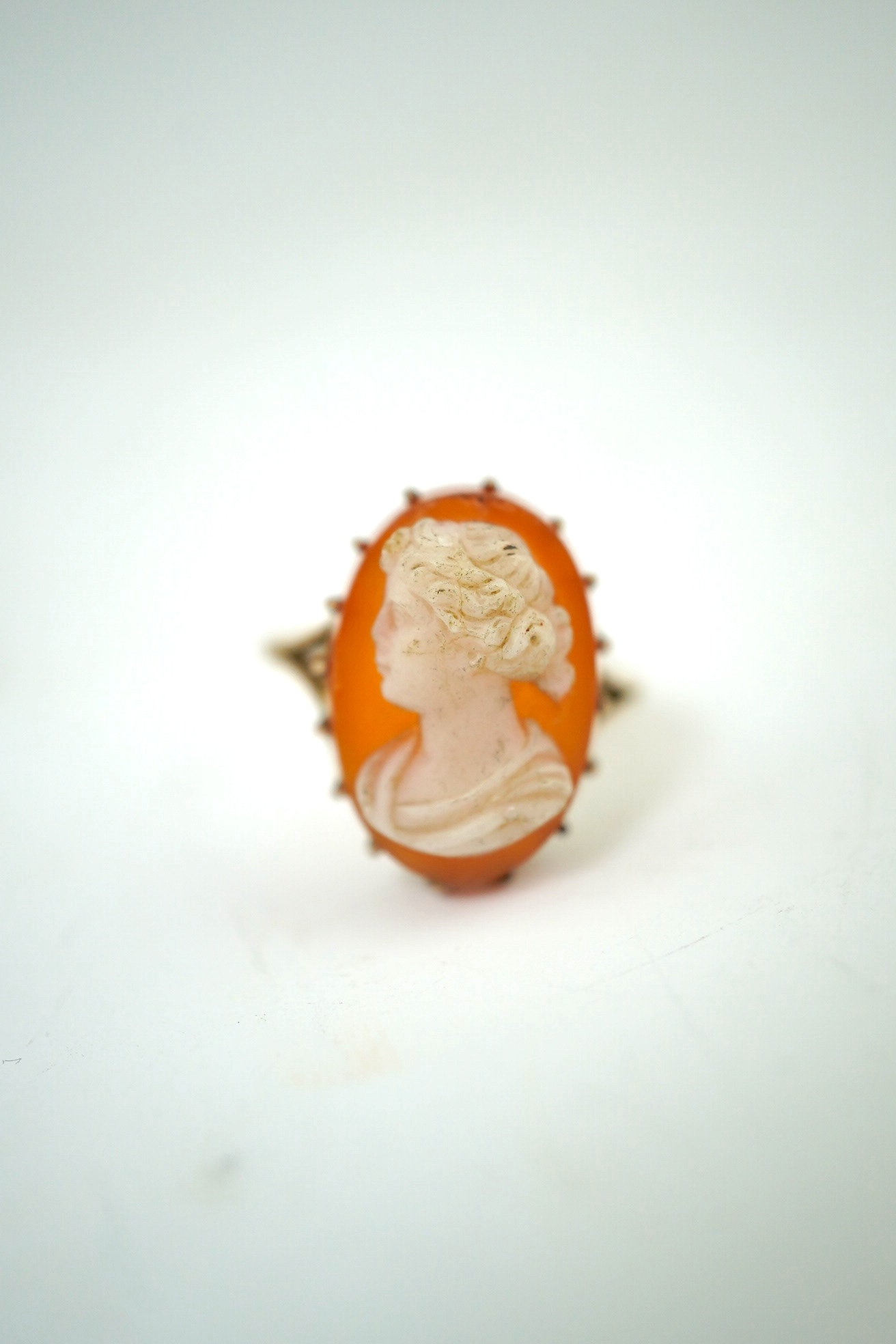 A yellow metal signet ring, stamped 18ct., 5.1 g, a cameo ring, indistinct Mark, 4.46 g gross and a reversible brooch. Condition - incomplete otherwise fair